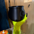 Witch Hand Holding a Cauldron