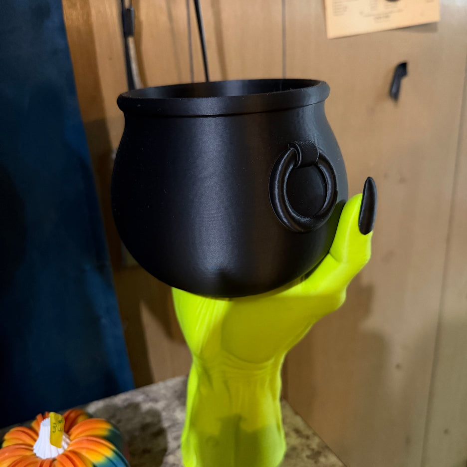 Witch Hand Holding a Cauldron